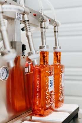 Several bottles of liquid in a factory

AI-generated content may be incorrect.